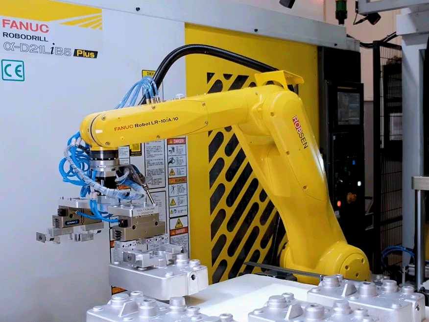 産業用ロボットが工作機械へワークをロードしている写真